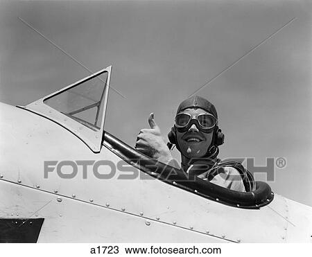 1940S Smiling Army Air Corps Pilot In Open Cockpit Wearing A Leather Flying Helmet Giving A Thumbs-Up Sign View Large Photo Image Stock Image - 1940S Smiling Army Air Corps Pilot In Open Cockpit Wearing A Leather Flying Helmet Giving A Thumbs-Up Sign. Fotosearch