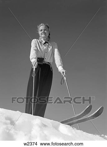 1940S Smiling Blond Woman Skier Poised On Hill Top To Begin Downhill Skiing Winter Outdoor View Large Photo Image Picture - 1940S Smiling Blond Woman Skier Poised On Hill Top To Begin Downhill Skiing Winter Outdoor. Fotosearch
