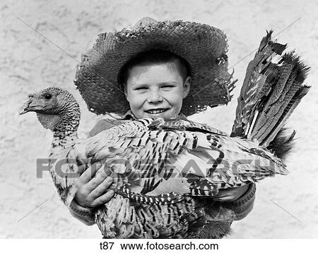 1940S Smiling Boy In Straw Farmer Hat Holding Turkey In Arms Looking At Camera View Large Photo Image Stock Photo - 1940S Smiling Boy In Straw Farmer Hat Holding Turkey In Arms Looking At Camera. Fotosearch
