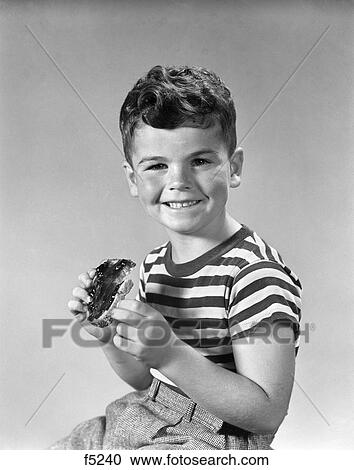 Stock Image - 1940S Smiling Boy Striped Tee Shirt Eating Bread With Jelly. Fotosearch