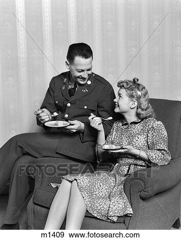 Stock Photo - 1940S Smiling Couple Eating Dessert Man In Army Uniform. Fotosearch