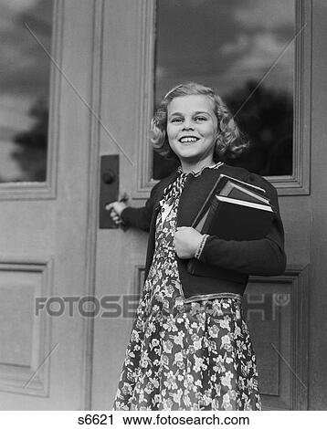 1940S Smiling Girl Print Dress Holding School Books Opening Door View Large Photo Image Stock Image - 1940S Smiling Girl Print Dress Holding School Books Opening Door. Fotosearch