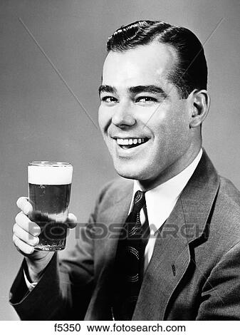 1940S Smiling Man Holding Glass Of Beer View Large Photo Image Stock Image - 1940S Smiling Man Holding Glass Of Beer. Fotosearch