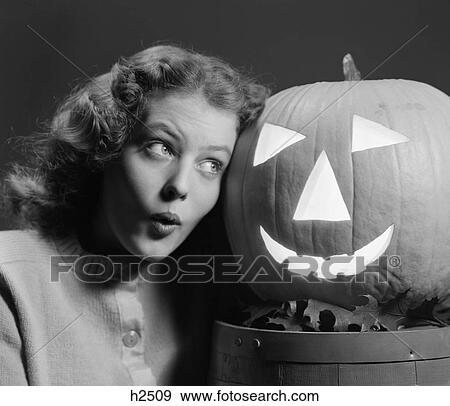 1940S Teen Girl Look Scared Head To Head With Carved Pumpkin Jack-O-Lantern View Large Photo Image Stock Photo - 1940S Teen Girl Look Scared Head To Head With Carved Pumpkin Jack-O-Lantern. Fotosearch
