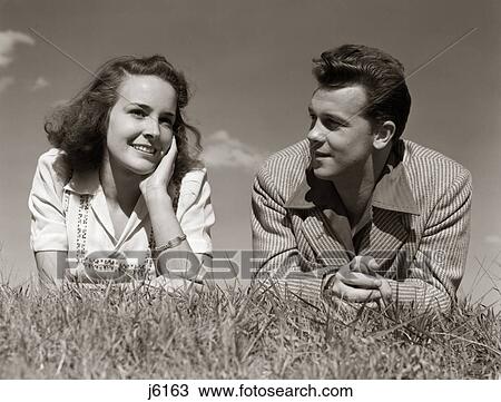 1940S Teenage Couple Lying In Grass Romance Boy Girl Outdoor View Large Photo Image Stock Image - 1940S Teenage Couple Lying In Grass Romance Boy Girl Outdoor. Fotosearch