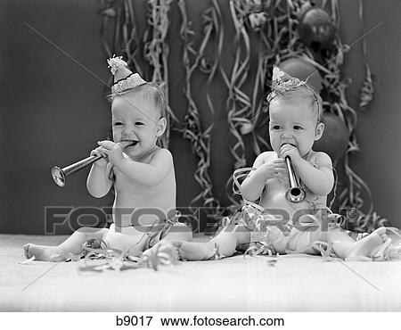 1940S Twin Babies With Party Hats Horns And Paper Streamers New Year Celebration Studio View Large Photo Image Stock Photo - 1940S Twin Babies With Party Hats Horns And Paper Streamers New Year Celebration Studio. Fotosearch