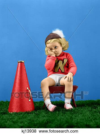 Stock Photo - 1940S Unhappy Frustrated Sad Little Girl Cheerleader Wearing A Cap Varsity Sports Sweater . Fotosearch