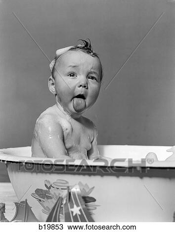 1940S Wet Baby In Bath Covered With Soap Suds Sticking Out Tongue View Large Photo Image Stock Image - 1940S Wet Baby In Bath Covered With Soap Suds Sticking Out Tongue. Fotosearch