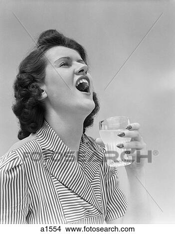 Picture - 1940S Woman Gargling Holding A Glass . Fotosearch