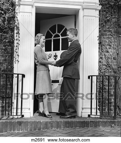 1940S Woman Greeting Man In Soldiers Uniform At Front Door View Large Photo Image Stock Image - 1940S Woman Greeting Man In Soldiers Uniform At Front Door. Fotosearch