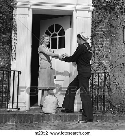 1940S Woman Greeting Man Sailor At Front Door View Large Photo Image Stock Image - 1940S Woman Greeting Man Sailor At Front Door. Fotosearch