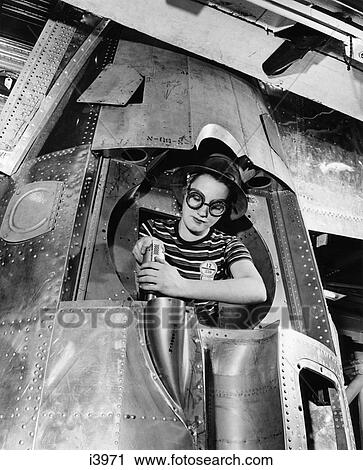 1940S Woman Riveter Drilling A Hole In A B-17 Bomber Engine View Large Photo Image Stock Image - 1940S Woman Riveter Drilling A Hole In A B-17 Bomber Engine. Fotosearch