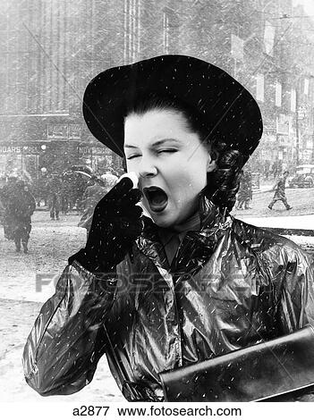 Stock Photo - 1940S Woman Sneezing Wearing Raincoat City Street Scene Background. Fotosearch