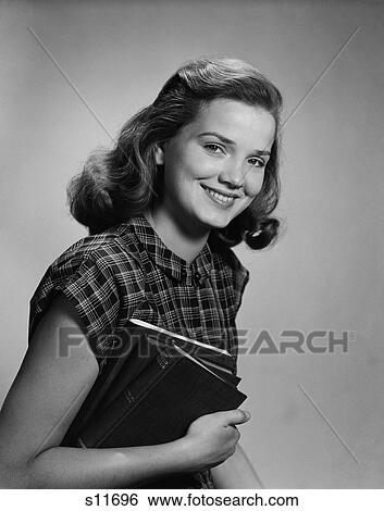 1940S Young Smiling Woman Holding Books Looking At Camera View Large Photo Image Stock Photograph - 1940S Young Smiling Woman Holding Books Looking At Camera. Fotosearch