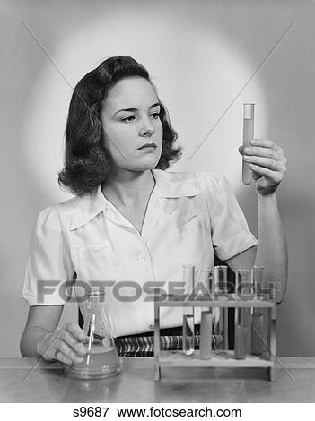 1940S Young Woman Chemist Holding Up Test Tube View Large Photo Image Stock Photo - 1940S Young Woman Chemist Holding Up Test Tube. Fotosearch