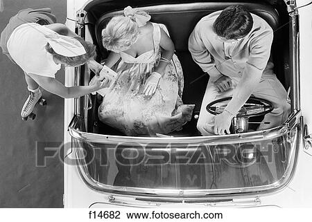 1950S 1960S Aerial View Of Carhop On Roller Skates Taking Order From Couple In Convertible Automobile View Large Photo Image Stock Image - 1950S 1960S Aerial View Of Carhop On Roller Skates Taking Order From Couple In Convertible Automobile. Fotosearch
