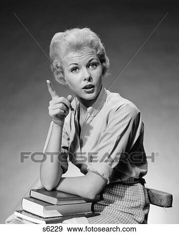 1950S 1960S Blond Woman Stack Of Books In Her Lap Shaking Finger Pointing View Large Photo Image Stock Photo - 1950S 1960S Blond Woman Stack Of Books In Her Lap Shaking Finger Pointing. Fotosearch