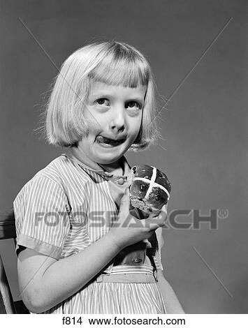 Picture - 1950S 1960S Blonde Girl Licking Her Lips Eating Hot Cross Bun. Fotosearch