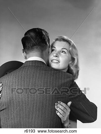 1950S 1960S Blonde Woman Hugging Man With His Back To The Camera View Large Photo Image Stock Image - 1950S 1960S Blonde Woman Hugging Man With His Back To The Camera. Fotosearch