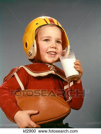 1950S 1960S Boy Drinking Glass Milk Wearing Football Helmet Shoulder Pads View Large Photo Image Stock Image - 1950S 1960S Boy Drinking Glass Milk Wearing Football Helmet Shoulder Pads . Fotosearch