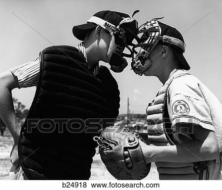 Stock Photo - 1950S 1960S Close-Up Of Little League Umpire & Catcher Arguing Face To Face. Fotosearch