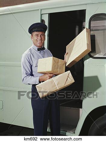 1950S 1960S Delivery Truck Driver Holding Packages View Large Photo Image Stock Image - 1950S 1960S Delivery Truck Driver Holding Packages . Fotosearch