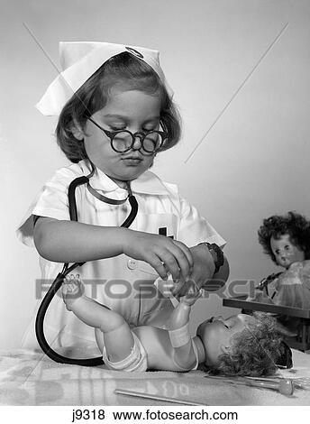 Stock Photo - 1950S 1960S Girl Wearing Nurse Uniform Eyeglasses Putting Bandage On Doll'S Arm . Fotosearch