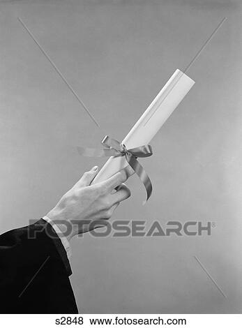 Stock Photo - 1950S 1960S Male Hand Holding Graduation Diploma. Fotosearch