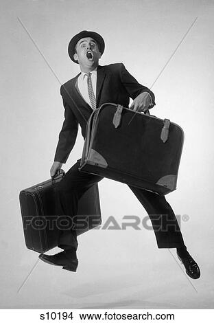 1950S 1960S Man Salesman Businessman With Two Suitcases Running Jumping Excited Looking At Camera View Large Photo Image Picture - 1950S 1960S Man Salesman Businessman With Two Suitcases Running Jumping Excited Looking At Camera. Fotosearch