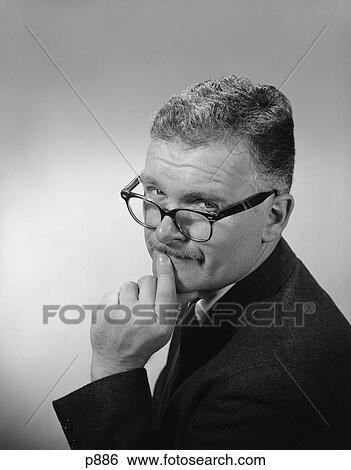 1950S 1960S Middle Aged Man Wearing Eyeglasses Low On Nose Quizzical Facial Expression View Large Photo Image Stock Photograph - 1950S 1960S Middle Aged Man Wearing Eyeglasses Low On Nose Quizzical Facial Expression. Fotosearch