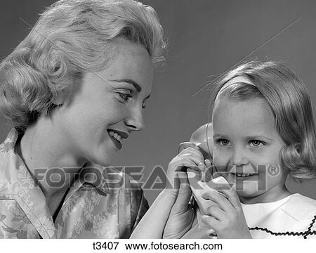 1950S 1960S Mother Watching Daughter Talking On Telephone View Large Photo Image Stock Photo - 1950S 1960S Mother Watching Daughter Talking On Telephone. Fotosearch