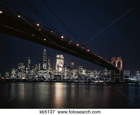 1950S 1960S Night View Of Lower Manhattan Island Skyline Beneath The Brooklyn Bridge View Large Photo Image Stock Photo - 1950S 1960S Night View Of Lower Manhattan Island Skyline Beneath The Brooklyn Bridge. Fotosearch