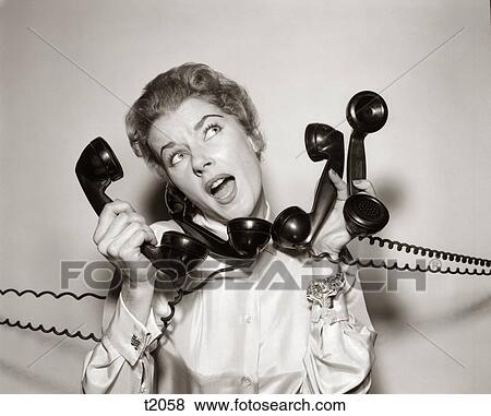 1950S 1960S Overwhelmed Stressed Woman Holding Answering Four Black Telephone Phone Receivers At One Time View Large Photo Image Stock Photo - 1950S 1960S Overwhelmed Stressed Woman Holding Answering Four Black Telephone Phone Receivers At One Time. Fotosearch