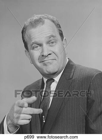 1950S 1960S Portrait Man Wearing Suit Tie Smiling Pointing Finger Looking At Camera View Large Photo Image Stock Photo - 1950S 1960S Portrait Man Wearing Suit Tie Smiling Pointing Finger Looking At Camera. Fotosearch