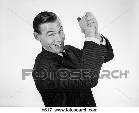 Stock Photo - 1950S 1960S Smiling Businessman Hands Clasped Overhead In Successful Winner Symbolic Sign. Fotosearch