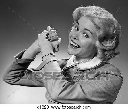 1950S 1960S Smiling Woman Making Winning Symbolic Hand Gesture With Raised Clasped Hands View Large Photo Image Stock Image - 1950S 1960S Smiling Woman Making Winning Symbolic Hand Gesture With Raised Clasped Hands. Fotosearch