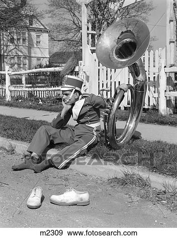 Stock Photo - 1950S 1960S Teen Boy Band Uniform & Tuba Sitting On Curb With Shoes Off. Fotosearch