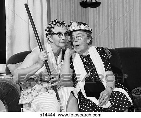 1950S 1960S Two Elderly Women Characters Gossiping One Woman With Hair Curlers Other With Hat View Large Photo Image Picture - 1950S 1960S Two Elderly Women Characters Gossiping One Woman With Hair Curlers Other With Hat. Fotosearch