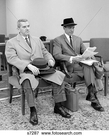 1950S 1960S Two Men Businessman Salesman Sitting In Office Reception Waiting Area Indoor View Large Photo Image Stock Photo - 1950S 1960S Two Men Businessman Salesman Sitting In Office Reception Waiting Area Indoor. Fotosearch