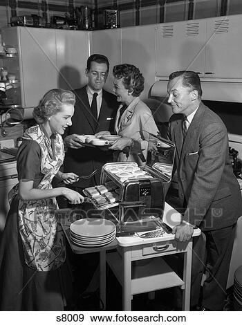 1950S 2 Couples In Kitchen Woman Cooking Ham & Eggs In Chrome Broiler View Large Photo Image Stock Photo - 1950S 2 Couples In Kitchen Woman Cooking Ham & Eggs In Chrome Broiler. Fotosearch
