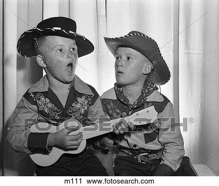 1950S 2 Juvenile Boys In Cowboy Hat & Shirts Playing Ukulele & Singing Mouth Open Wide View Large Photo Image Stock Image - 1950S 2 Juvenile Boys In Cowboy Hat & Shirts Playing Ukulele & Singing Mouth Open Wide . Fotosearch