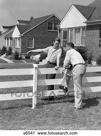 1950S 2 Men Neighbors Talking Over White Wooden Fence Between Suburban Houses View Large Photo Image Stock Image - 1950S 2 Men Neighbors Talking Over White Wooden Fence Between Suburban Houses. Fotosearch