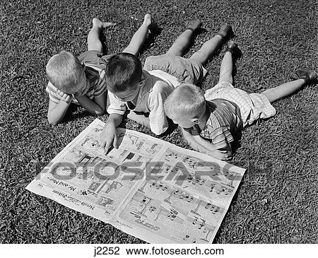 1950S 3 Boys Reading Funnies On Lawn View Large Photo Image Stock Image - 1950S 3 Boys Reading Funnies On Lawn . Fotosearch