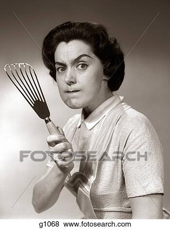1950S-60S Portrait Of Angry Housewife Brandishing Spatula At Camera View Large Photo Image Stock Photo - 1950S-60S Portrait Of Angry Housewife Brandishing Spatula At Camera. Fotosearch