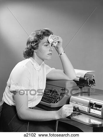 1950S Ailing Woman Secretary Sitting At Desk With Typewriter And Dictation Machine Holding Handkerchief To Forehead View Large Photo Image Stock Image - 1950S Ailing Woman Secretary Sitting At Desk With Typewriter And Dictation Machine Holding Handkerchief To Forehead. Fotosearch