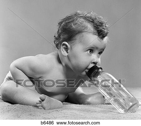 1950S Baby Sitting Leaning Forward Drinking From Bottle Studio Indoor View Large Photo Image Stock Photograph - 1950S Baby Sitting Leaning Forward Drinking From Bottle Studio Indoor. Fotosearch