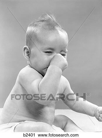 Stock Image - 1950S Baby With Closed Eyes Holding Nose. Fotosearch