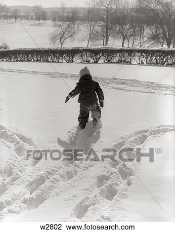 1950S Back View Child In Snowsuit Making Tracks In Fresh Snow Outdoor View Large Photo Image Stock Image - 1950S Back View Child In Snowsuit Making Tracks In Fresh Snow Outdoor. Fotosearch