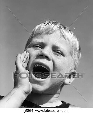 Picture - 1950S Blond Boy With Eyes Closed And Hand Cupping A Wide Open Mouth Shouting. Fotosearch
