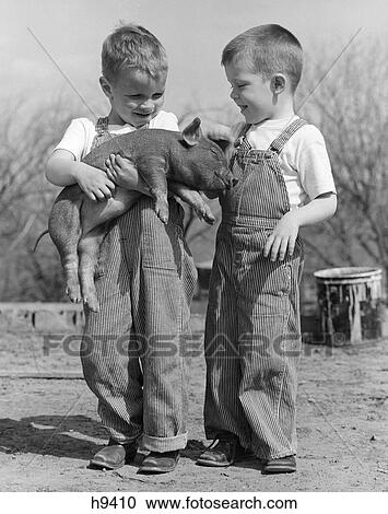 1950S Boys In Striped Overalls Holding Piglet View Large Photo Image Stock Image - 1950S Boys In Striped Overalls Holding Piglet. Fotosearch